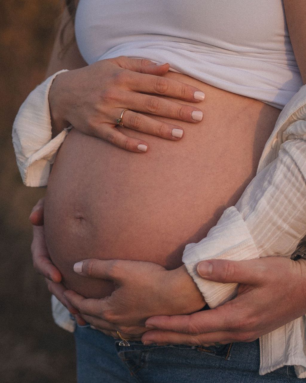 Expectant mother holding her belly